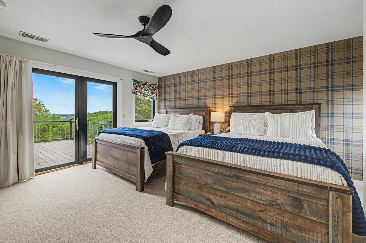 Bedroom with two queen beds and a balcony