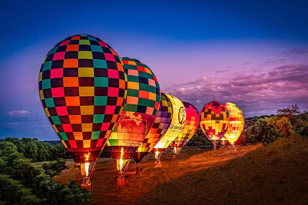 Hot air balloons glowing at dusk