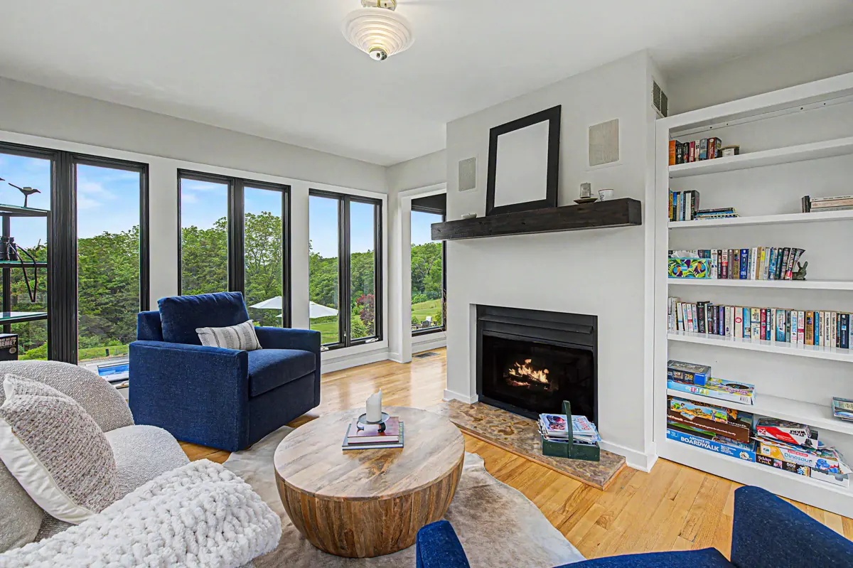 Four-season room with fireplace, bookshelves and valley views