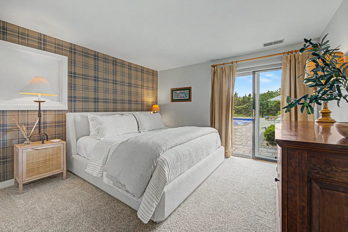 Poolside bedroom with king bed and sliding doors